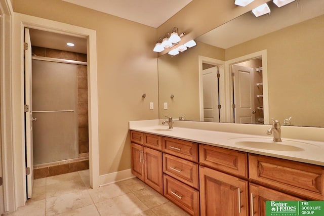 bathroom featuring vanity and a shower with shower door