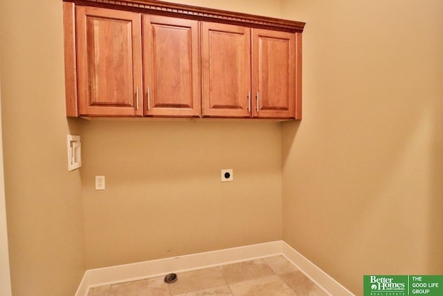 clothes washing area with cabinets and hookup for an electric dryer