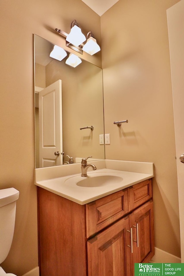 bathroom featuring vanity and toilet