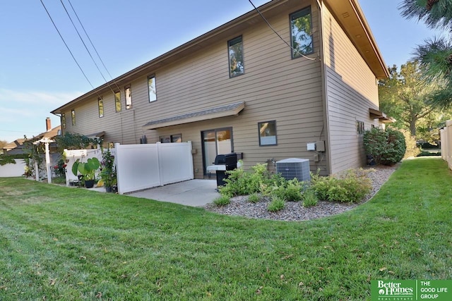 rear view of house featuring a yard, a patio, and central AC