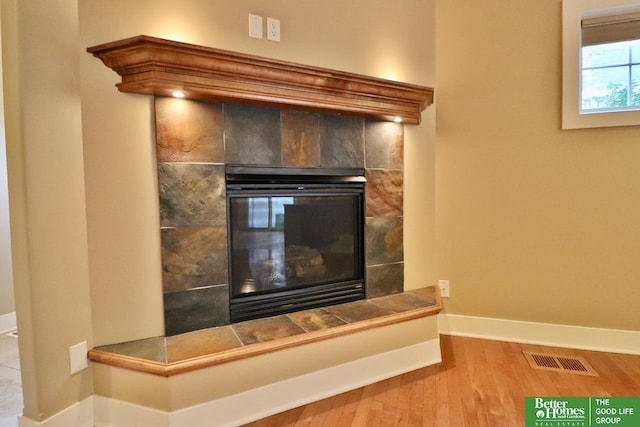 details featuring a fireplace and hardwood / wood-style flooring