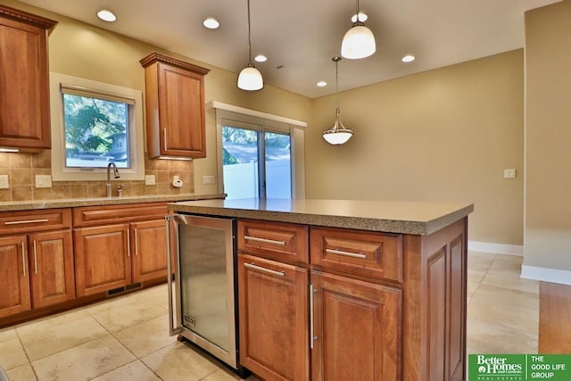 kitchen with backsplash, a healthy amount of sunlight, a kitchen island, and pendant lighting