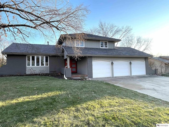 view of front facade with a garage and a front lawn