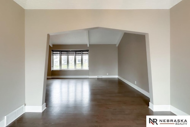 unfurnished room featuring dark wood-type flooring