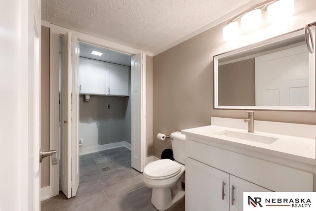 bathroom featuring vanity, toilet, and a textured ceiling