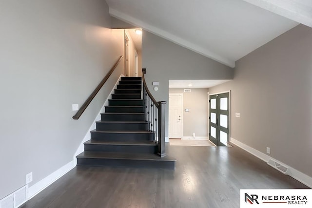 stairway with french doors, hardwood / wood-style flooring, and high vaulted ceiling