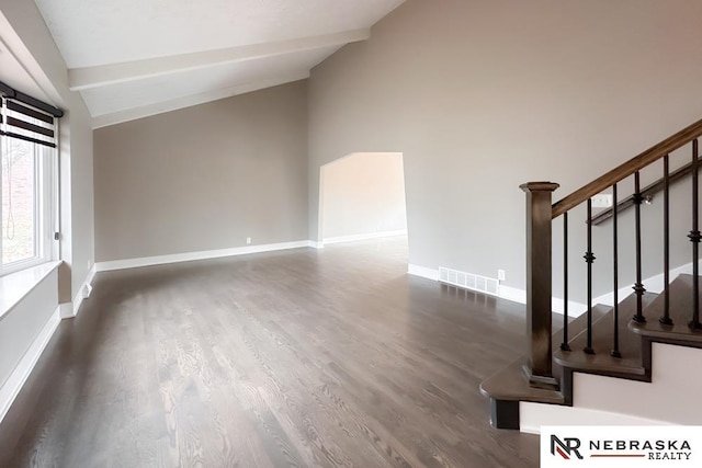 interior space with lofted ceiling with beams and dark hardwood / wood-style flooring