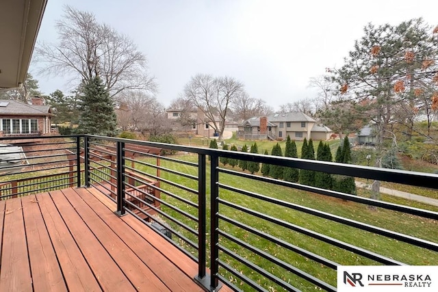 wooden terrace featuring a yard