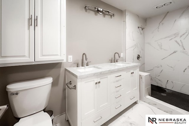 bathroom featuring vanity, toilet, and a tile shower