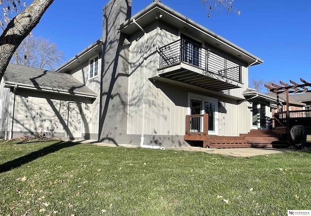 back of property featuring a lawn, a pergola, a balcony, and a deck