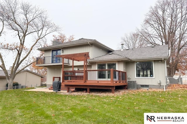 back of property featuring a lawn, a wooden deck, and a balcony