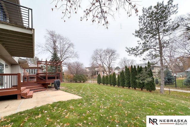 view of yard featuring a patio area, a pergola, and a wooden deck