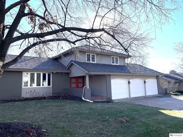 view of front of house featuring a garage and a front lawn