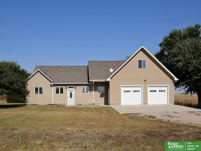 view of front of house featuring a garage and a front lawn