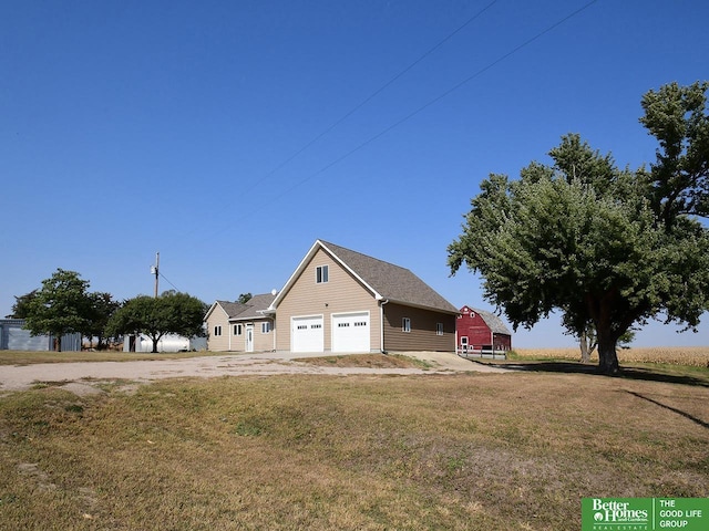 view of front of property with an outbuilding, a front yard, and a garage