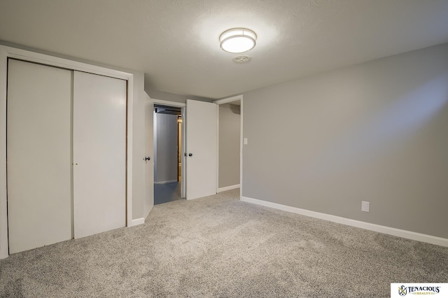 unfurnished bedroom with carpet flooring and a closet