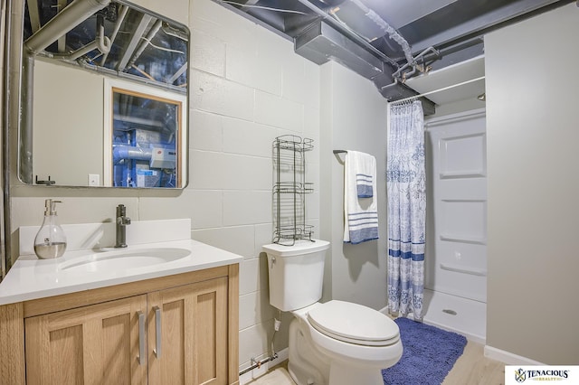 bathroom with vanity, hardwood / wood-style flooring, toilet, and walk in shower