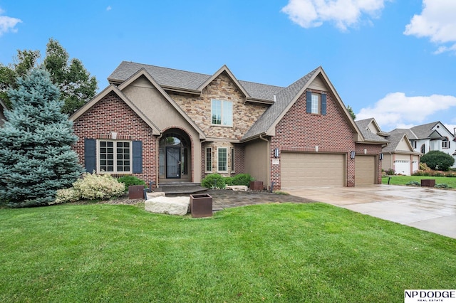 view of front of home featuring driveway, stone siding, an attached garage, a front yard, and brick siding