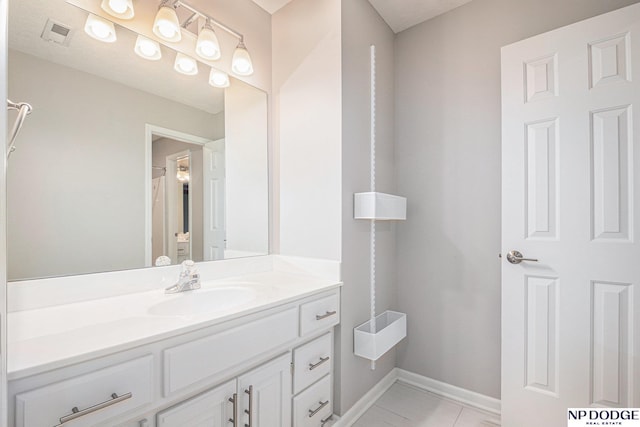 bathroom featuring tile patterned flooring and vanity