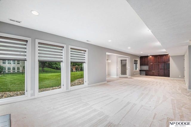 unfurnished living room featuring light carpet