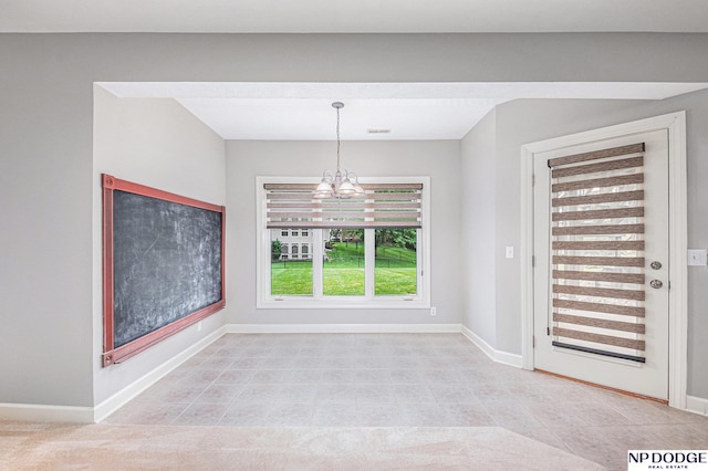 unfurnished dining area with a chandelier