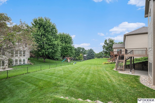 view of yard with a playground and a deck