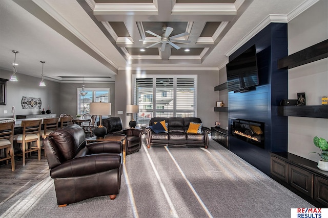 living room with beam ceiling, ceiling fan, coffered ceiling, a fireplace, and ornamental molding