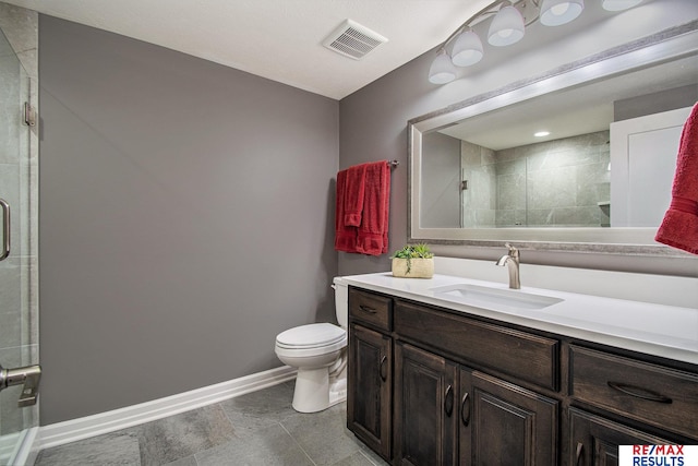 bathroom featuring vanity, toilet, and walk in shower