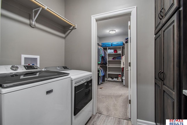 washroom with light hardwood / wood-style floors and independent washer and dryer