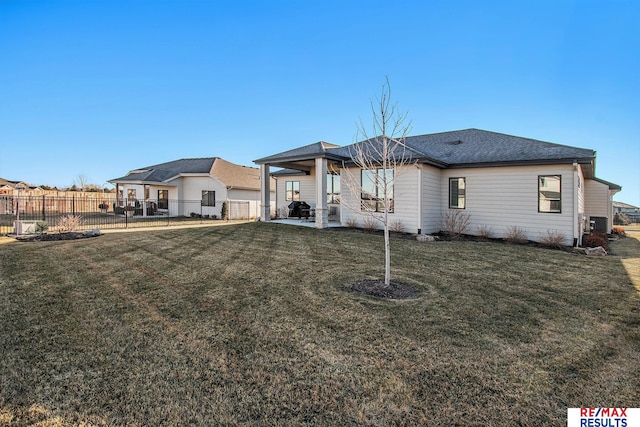 view of front of house with a patio and a front lawn