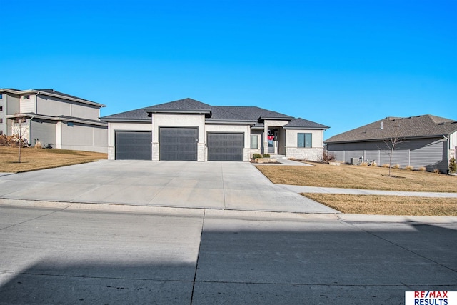 prairie-style house with a front yard and a garage