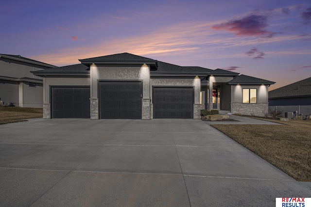 prairie-style house with a yard and a garage