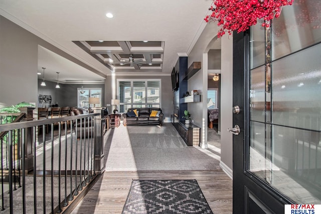 interior space with hardwood / wood-style floors, beam ceiling, crown molding, and coffered ceiling