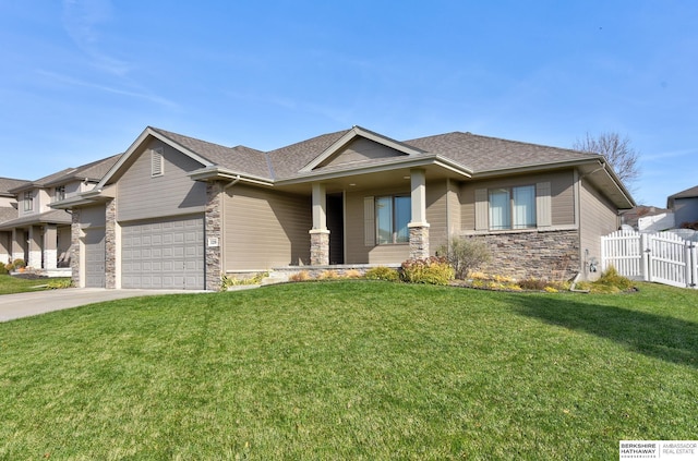 view of front of home featuring a porch, a garage, and a front yard