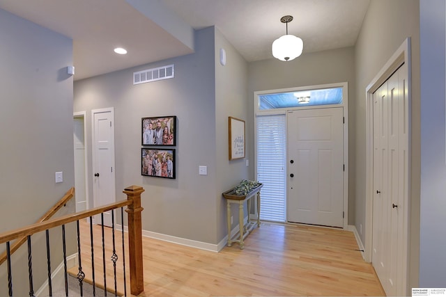 foyer with recessed lighting, visible vents, baseboards, and light wood-style flooring