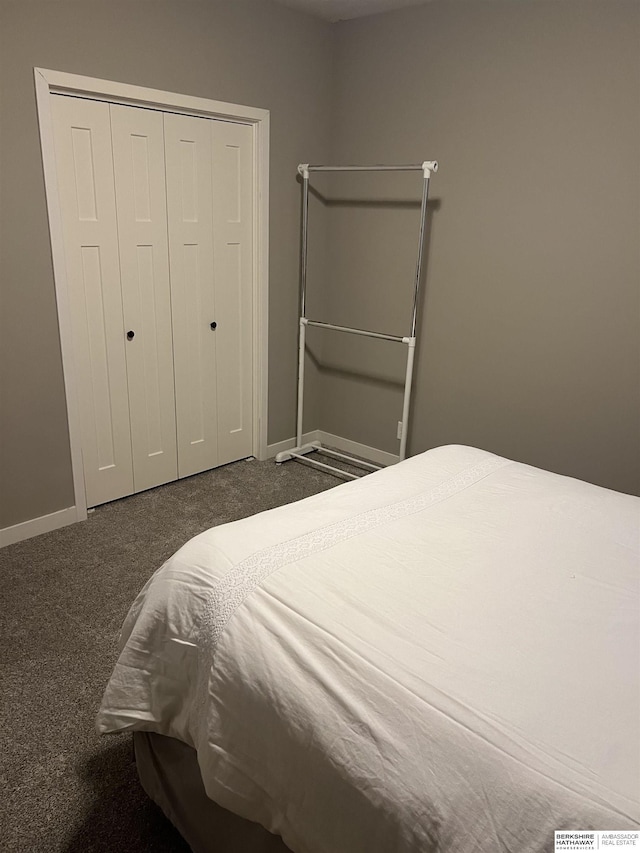 bedroom with a closet, baseboards, and carpet