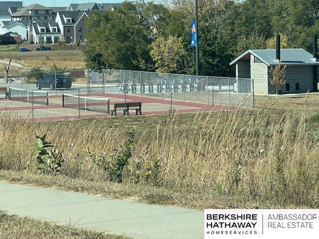 view of sport court featuring fence