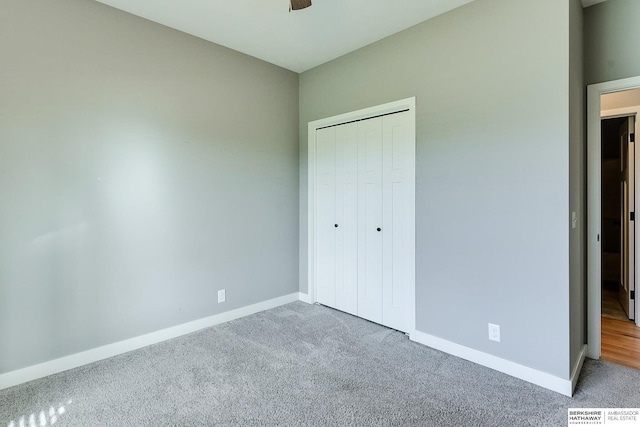 unfurnished bedroom featuring ceiling fan, a closet, and light colored carpet