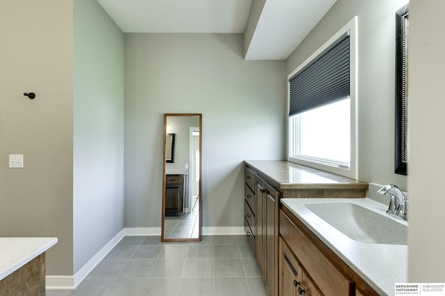 bathroom with tile patterned floors and vanity