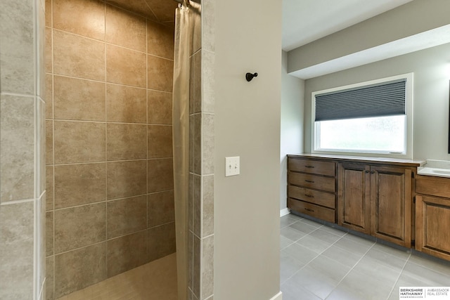 bathroom featuring tile patterned flooring, a shower with curtain, and vanity