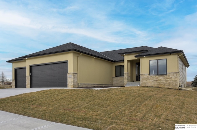 prairie-style house with a garage and a front yard