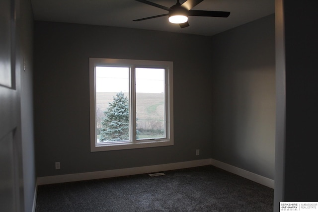 empty room with ceiling fan and carpet flooring