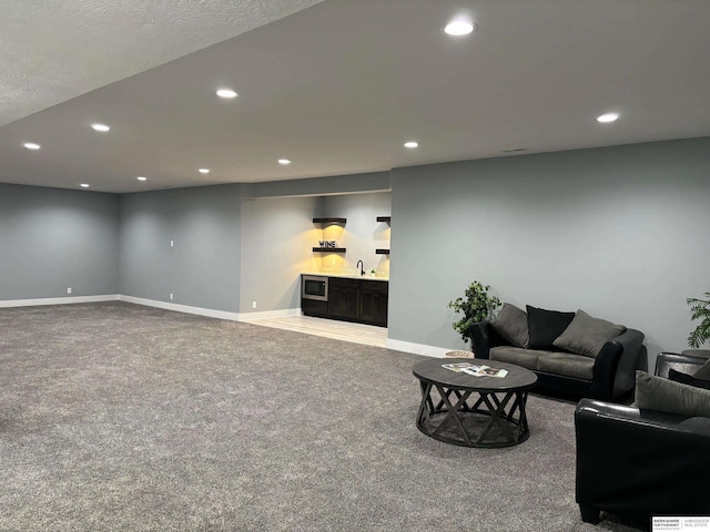 carpeted living room featuring bar