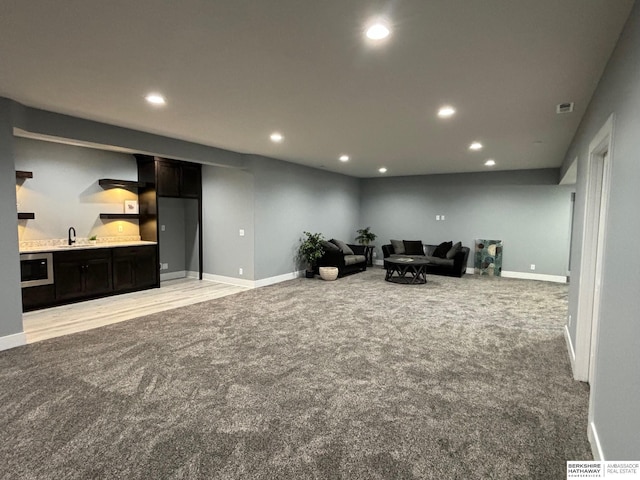 living room featuring light carpet and sink