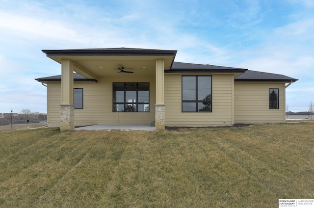 rear view of property featuring a patio, ceiling fan, and a lawn