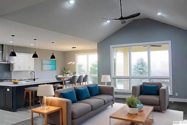 living room featuring ceiling fan, a healthy amount of sunlight, sink, and vaulted ceiling