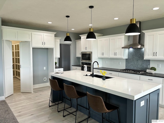 kitchen featuring hanging light fixtures, sink, and white cabinets