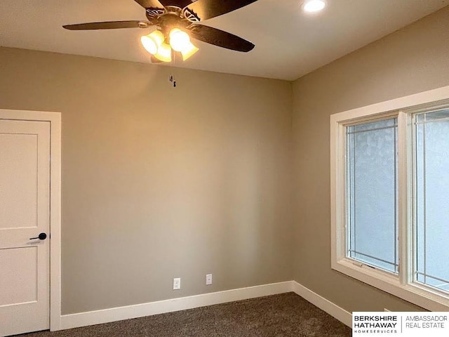 carpeted spare room featuring ceiling fan