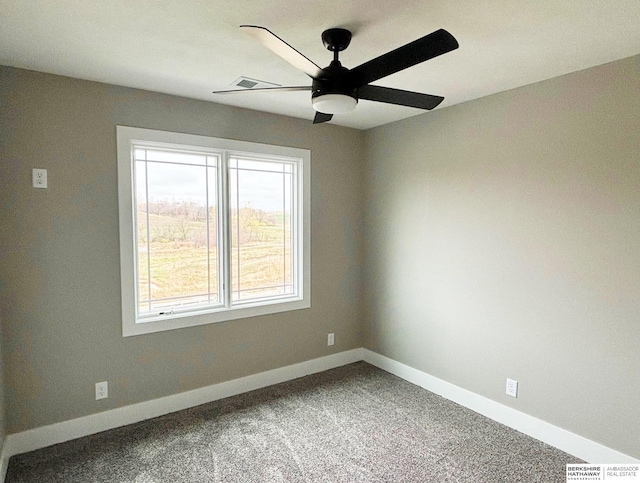 empty room featuring carpet floors and ceiling fan