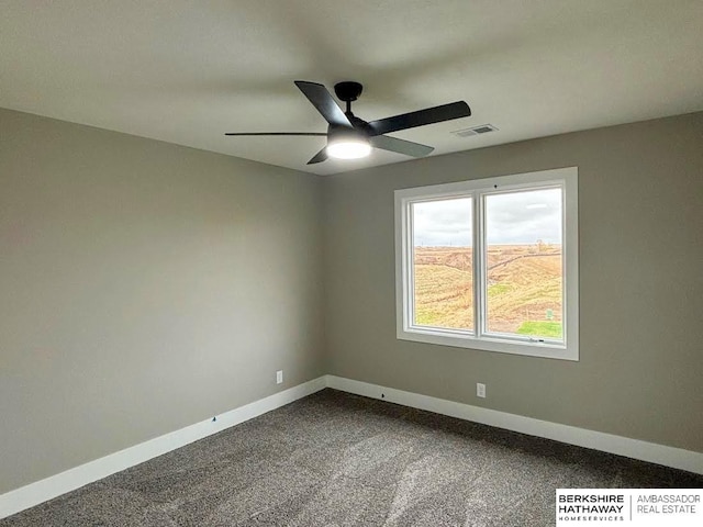 spare room featuring carpet and ceiling fan